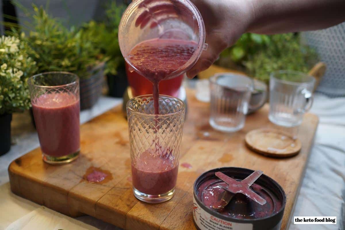 Coconut Berry Smoothie being poured from blender