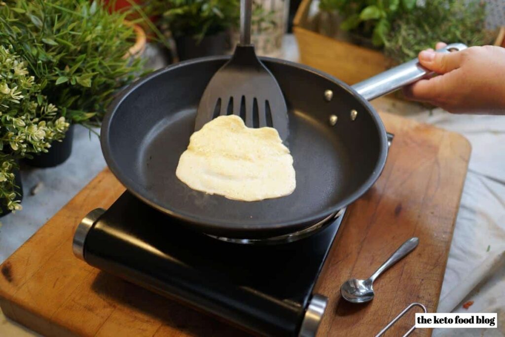 Flipping Keto Tortillas on a counter top stove