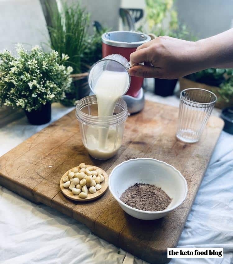 Pouring almond milk into nutribullet blender