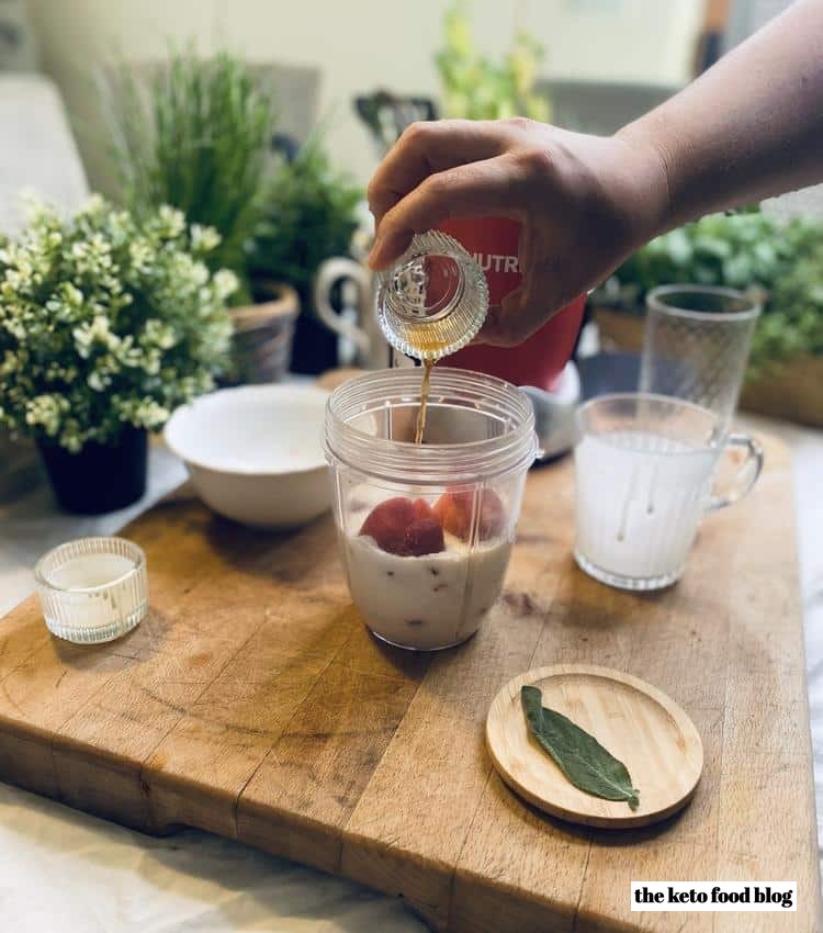 Pouring vanilla bean sweetener into a nutribullet cup