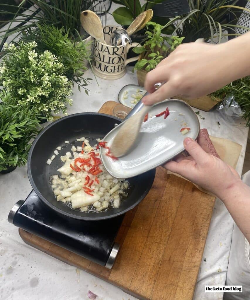 Stir frying the chopped vegetables in a pan