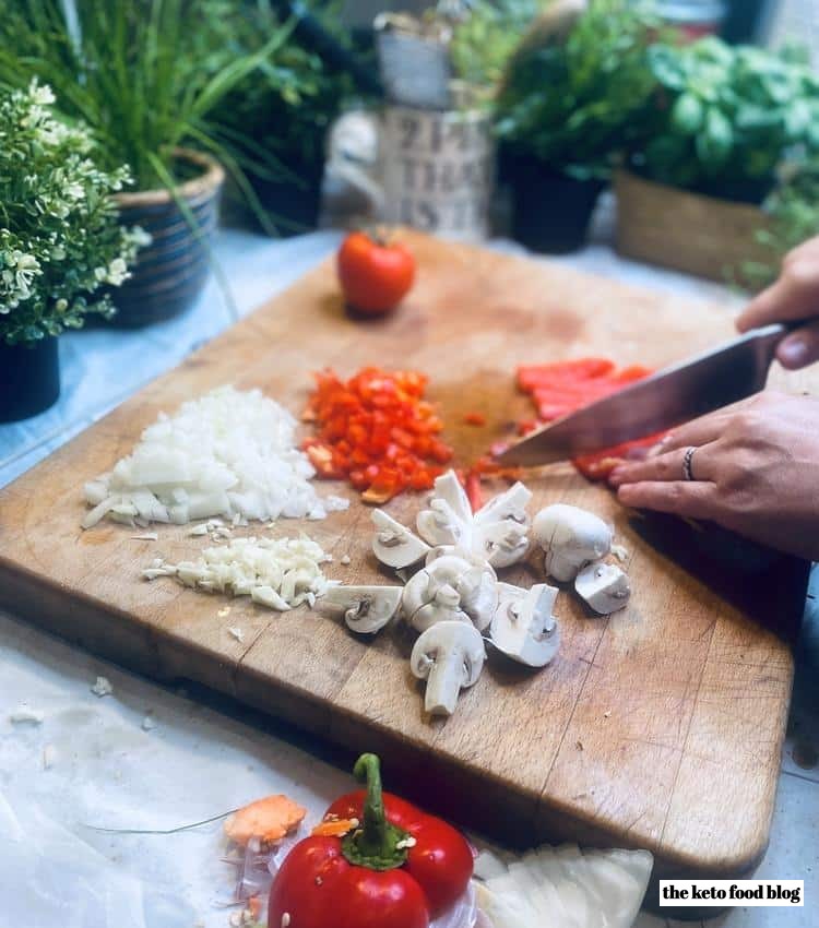 Chopping pepper, onion, garlic, tomatoes and mushrooms