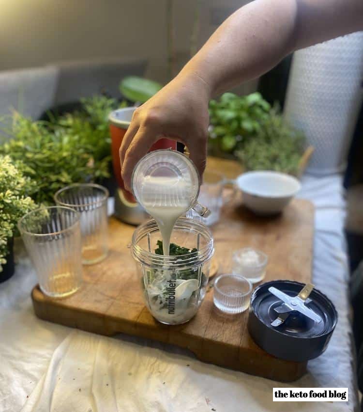 Almond milk being poured into blender