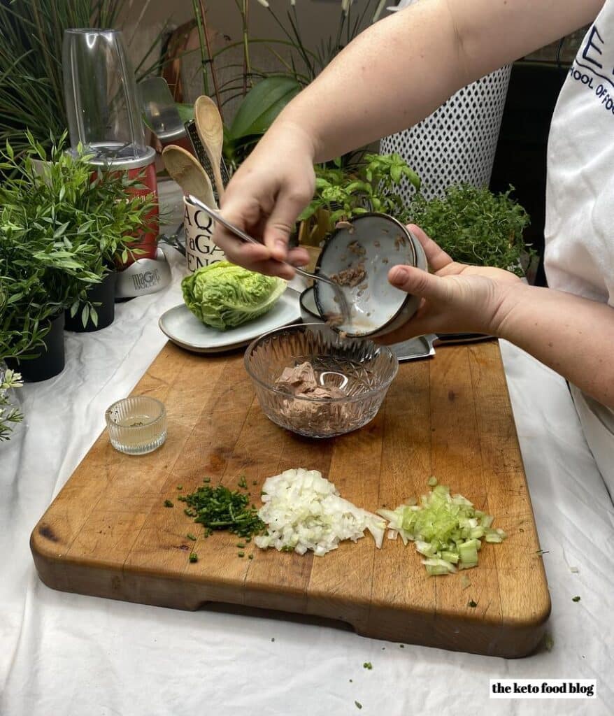 Preparing Lemon Dill Tuna Salad with chopped celery, onion and chives.