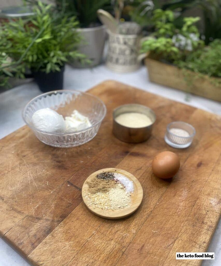 Ingredients for the keto pizza dough on a wooden chopping board