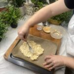 Spreading out keto pizza dough on a baking tray