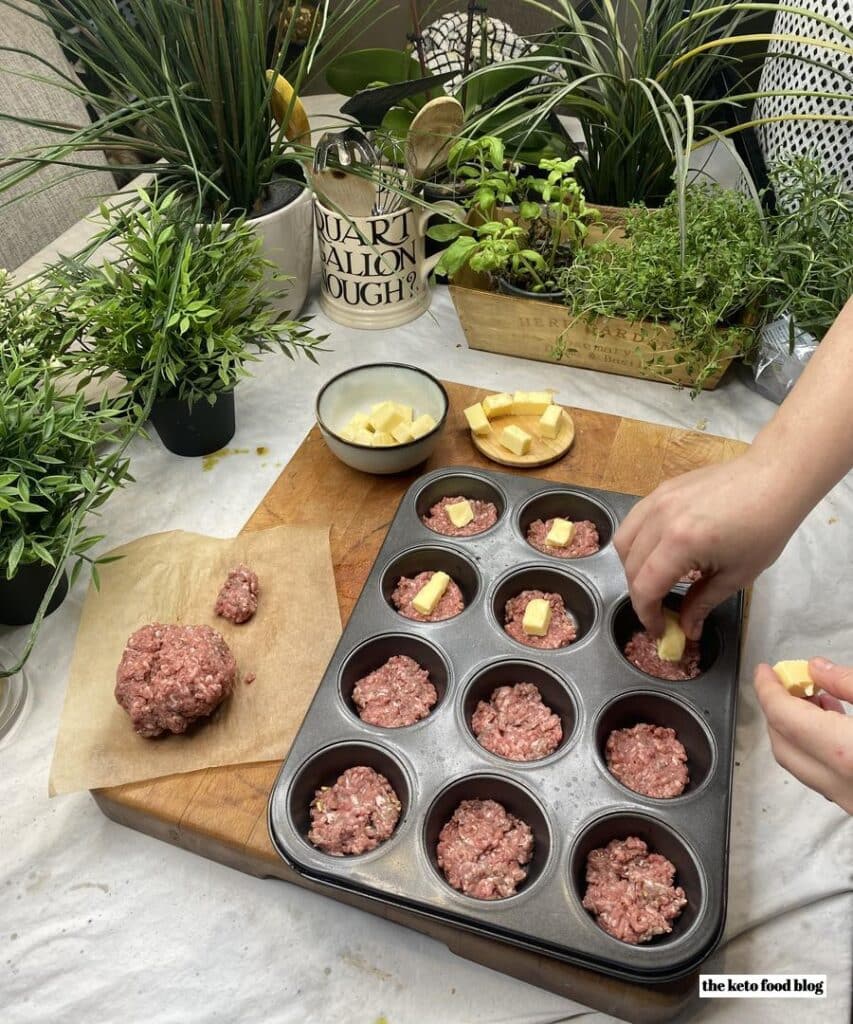 Encasing cubes of butter and cheese into ground beef for Keto Butter Burgers Fat Bomb