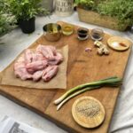 Ingredients for Sticky Keto Sesame Chicken Wings on a wooden chopping board