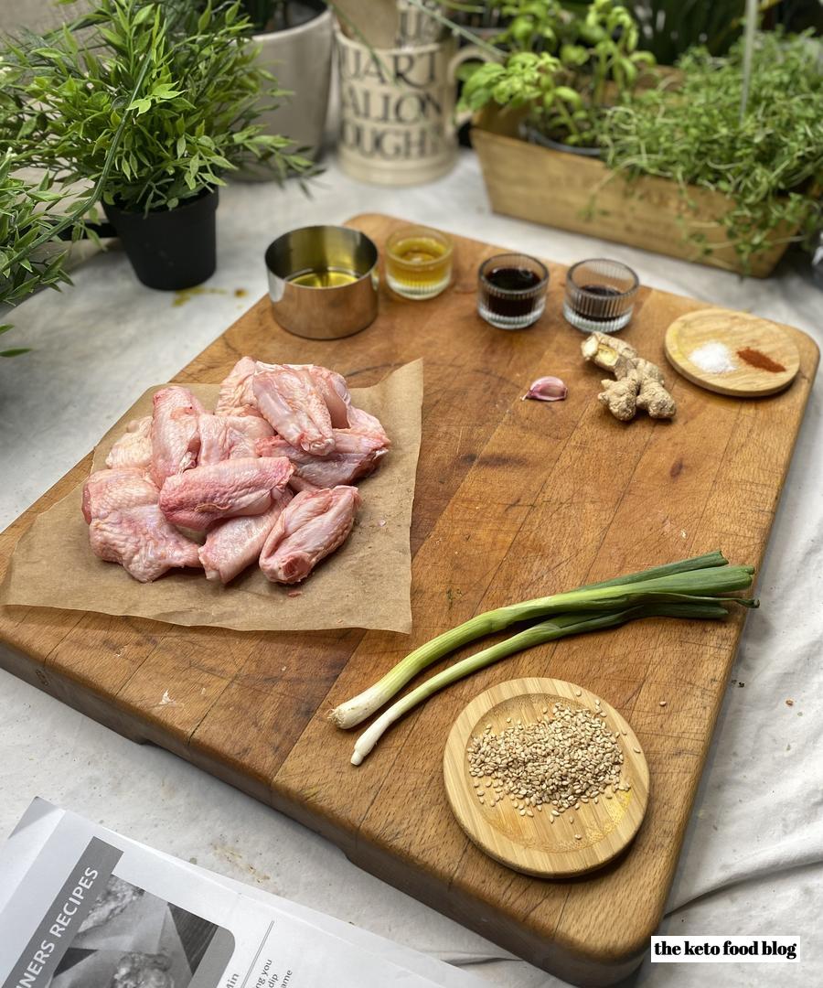Ingredients for Sticky Keto Sesame Chicken Wings on a wooden chopping board