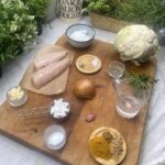 Ingredients for Keto Chicken Korma on a wooden chopping board