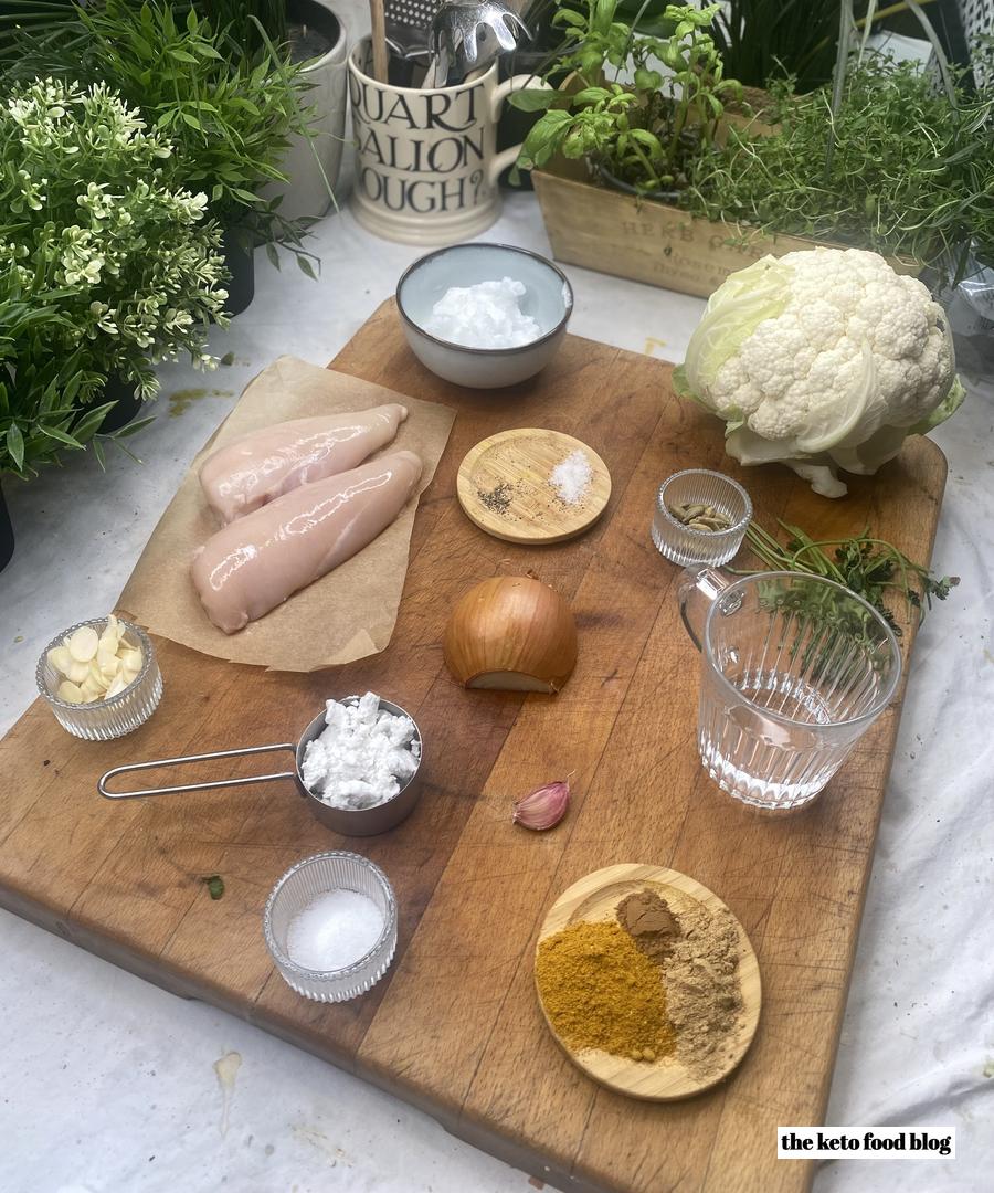 Ingredients for Keto Chicken Korma on a wooden chopping board