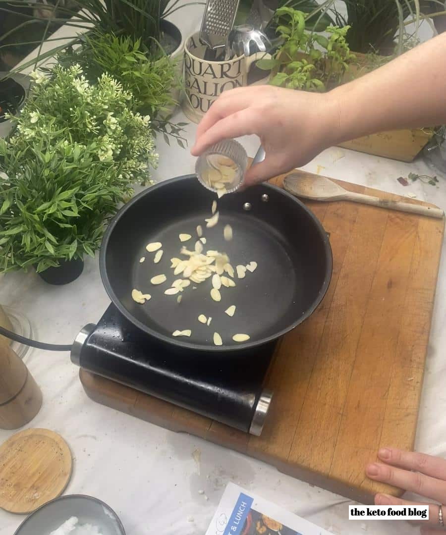 Dry frying sliced almonds in a pan