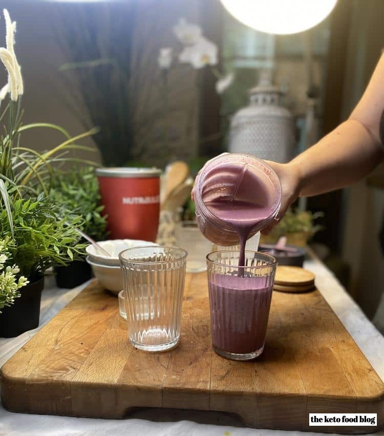 Pouring a purple smoothie from a nutribullet 