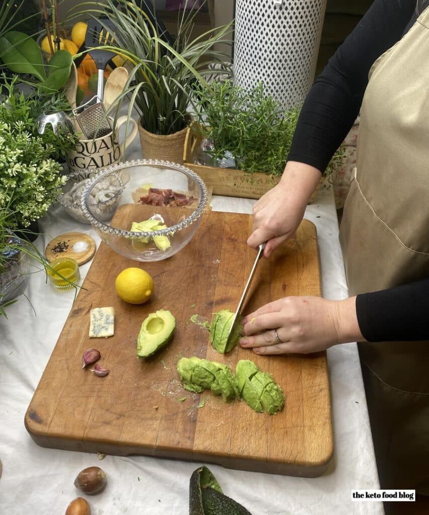 Chopping avocados on a wooden chopping board