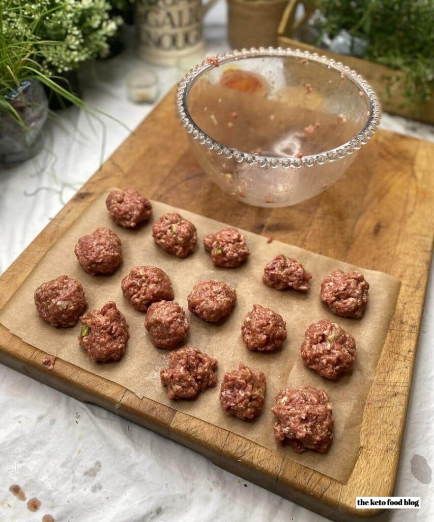 16 asian style meatballs on a baking tray