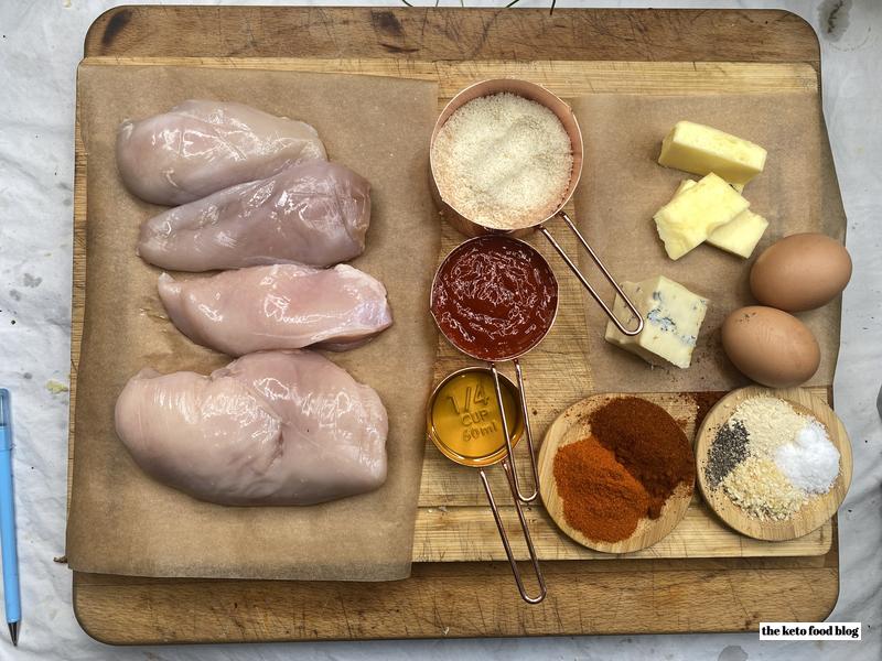 Ingredients presented on a wooden chopping board with copper containers